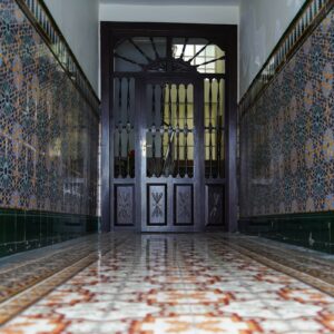 a hallway with a door and tiled floors