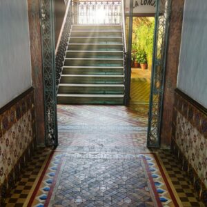 a hallway with a tiled floor and stairs
